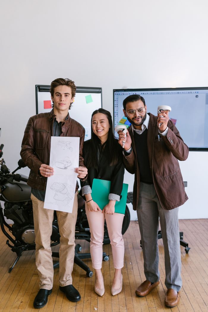 Three diverse entrepreneurs showcasing their startup ideas with creativity and collaboration indoors.